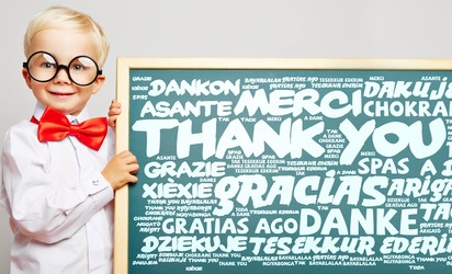 Boy in round glasses holding thank you sign